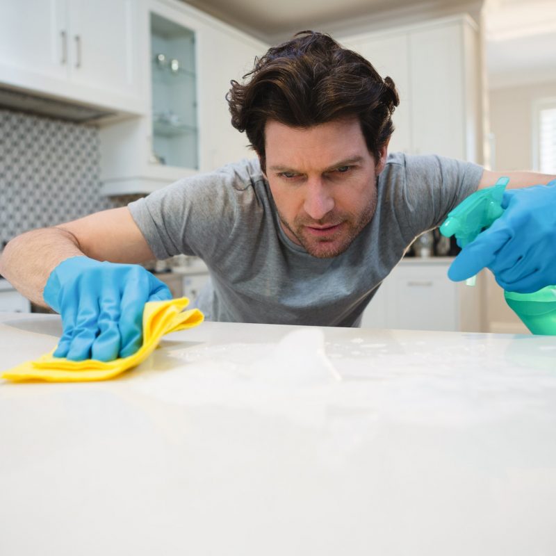 man-cleaning-kitchen-worktop-at-home.jpg